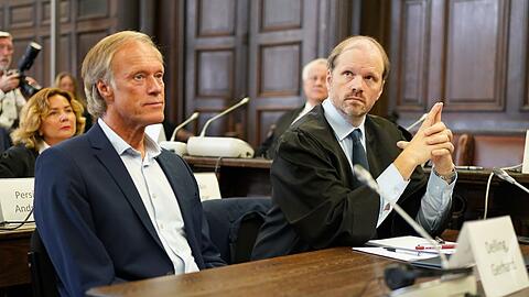 Gerhard Delling, gekleidet im dunklen Anzug ohne Krawatte, setzte sich gleich nach Betreten des Gerichtssaals neben seinen Anwalt.