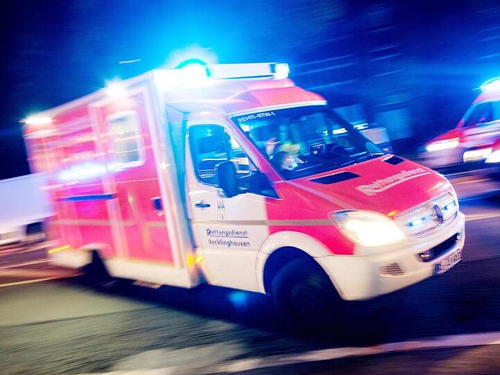 Ein Rettungswagen der Feuerwehr fährt mit Blaulicht durch eine Straße. Foto: Marcel Kusch/Archiv