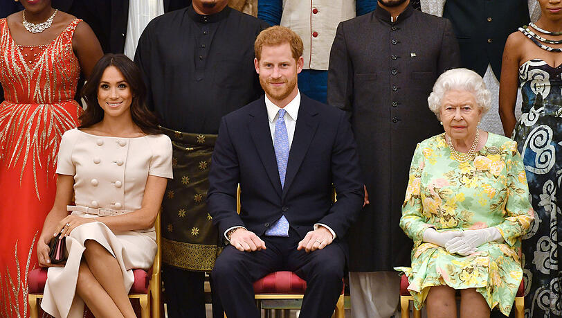 Königin Elizabeth II., Prinz Harry und dessen Frau Meghan.
