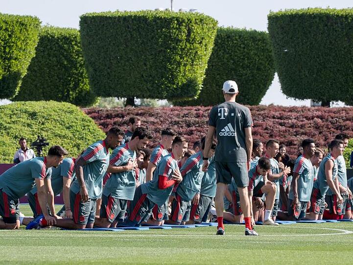 Die Spieler des Fußball-Bundesligisten FC Bayern München wärmen sich während einer Übungseinheit am Vormittag auf. Foto: Peter Kneffel