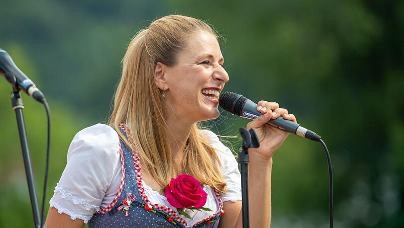 Sängerin und Fernsehmoderatorin Stefanie Hertel steht am Mikrofon.