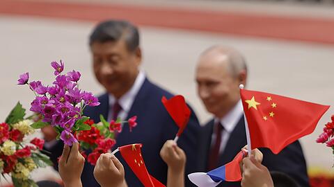 Mit Blumen und F&auml;hnchen empfingen chinesische Kinder den Gast aus Moskau.