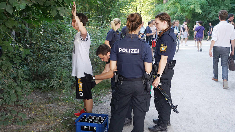 Ein junger Mann mit Biertragerl wird durchsucht.