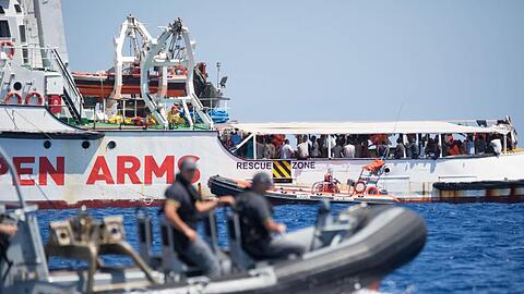 Ein Schlauchboot der der italienischen Küstenwache fährt um das Rettungsschiff "Open Arms" herum.