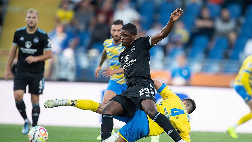 Nürnbergs Kwadwo Duah (l) spielt gegen Braunschweigs Jannis Nikolaou.