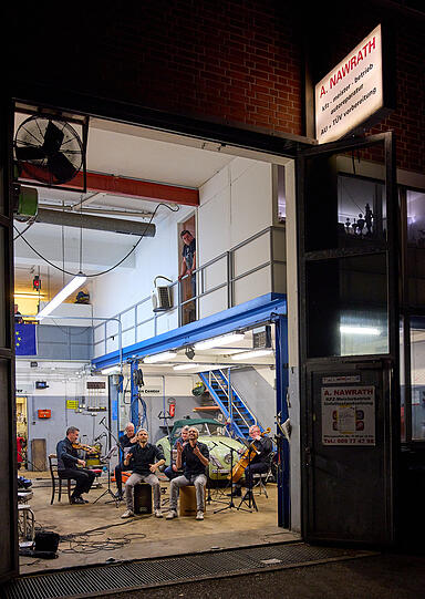 Als noch Harmonie herrschte: ein Konzert des M&uuml;nchener Kammerorchesters mit Double Drums in der Werkst&auml;tte von Auto Nawrath.