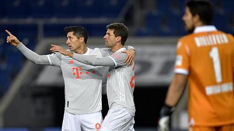 Bayerns Robert Lewandowski (l) und Thomas Müller bejubeln Müller's Tor zur Führung.