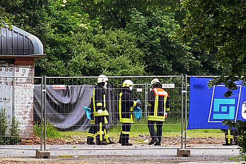 Feuerwehrmänner suchen am Mittwochmorgen das gelände ab, auf dem am Dienstag die Bombe expodierte