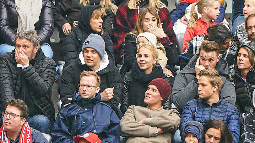 Manuel Neuer (m.) mit Ehefrau Nina beim Spiel des FC Bayern gegen Hannover 96 auf der Tribüne.