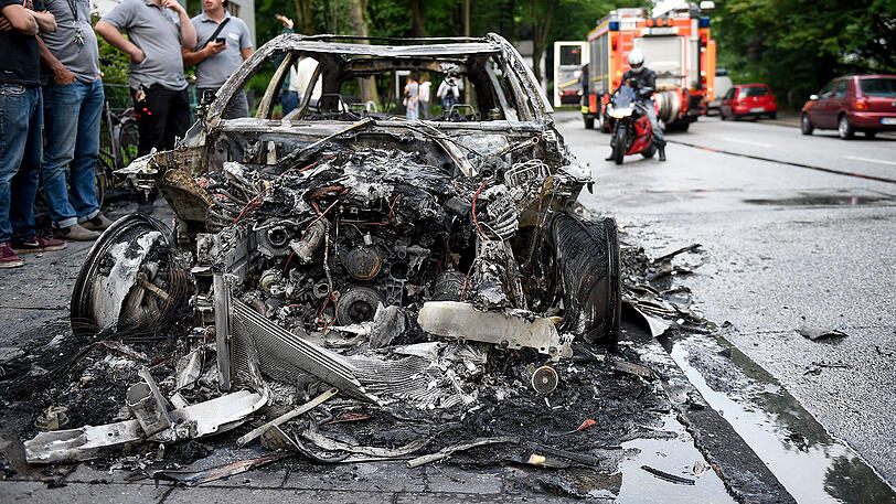 Nachwirkungen der Krawallnacht vor dem Gipfel-Auftakt am Freitag: Abgebrannte Autowracks - einige von ihnen brennen sogar noch.