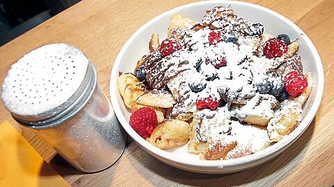 "Loaded Kaiserschmarrn" bei Superschmarrn. Hier die Variante "Lini" mit Nuss-Nougat-Creme, Beeren, Kokosraspeln und Puderzucker für neun Euro.