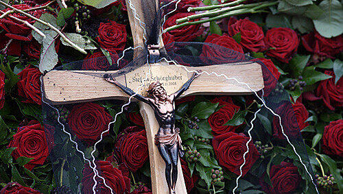 Ein schlichtes Kreuz auf roten Rosen ziert das Grab von Stefan Schörghuber Ein schlichtes Kreuz auf roten Rosen ziert das Grab von Stefan Schörghuber