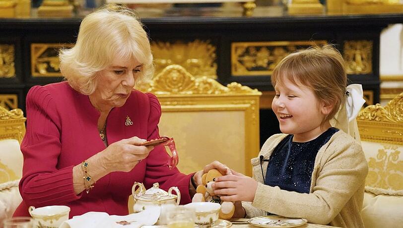 Königin Camilla und die siebenjährige Olivia genießen gemeinsam Tee auf Schloss Windsor.