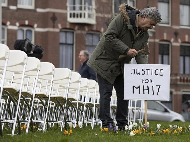 Eine Installation mit 298 symbolischen leeren Stühlen gegenüber der russischen Botschaft in Den Haag erinnert an die Opfer.