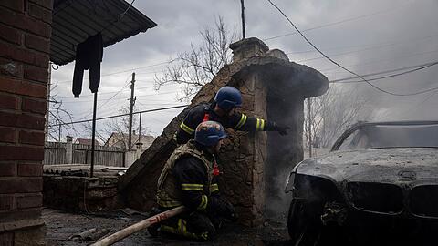 Rettungskräfte gehen nach Explosionen in Deckung, während sie versuchen, ein Feuer in einem Wohnviertel in Kostjantyniwka zu löschen.