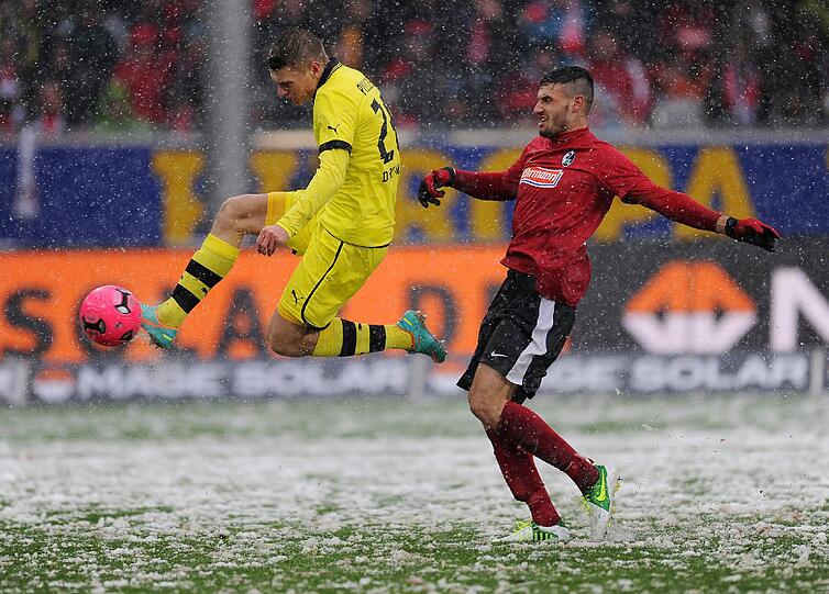 Die Bilder aus Freiburg. Die Linien müssen freigeräumt werden, der Ball ist rot und Spieler wie Trainer sind nicht zu beneiden. Doch dennoch wird gespielt.