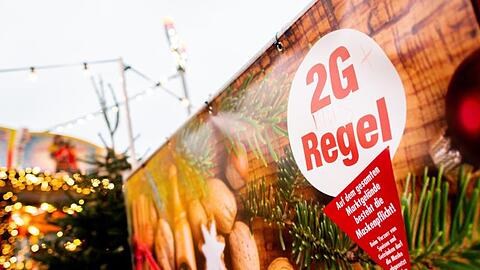 Ein Schild mit der Aufschrift "2G Regel" am Eingang eines Weihnachtsmarkts.