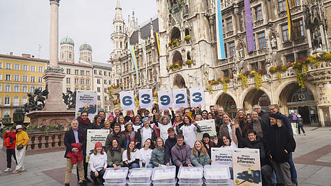 Die Initiatioren des Baumentscheids posieren gemeinsam mit Helfern, Vertretern der Stadtratsfraktionen und B&uuml;rgermeisterin Mona Fuchs vor dem Rathaus.