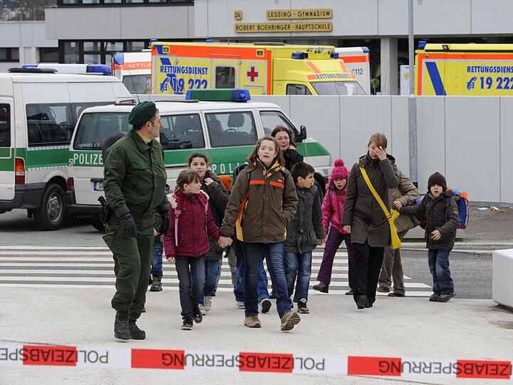 Ein Polizist schafft Winnender Schüler in Sicherheit.