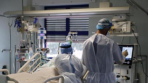 Eine Krankenschwester und ein Arzt kümmern sich um einen Patienten auf der Corona-Intensivstation in einem Lissaboner Krankenhaus.