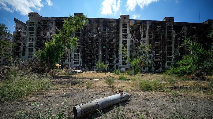 Ein Raketenteil in der Nähe eines beschädigten Wohnhauses in Sjewjerodonezk. Dieses Bild wurde während einer vom russischen Verteidigungsministerium organisierten Reise aufgenommen.