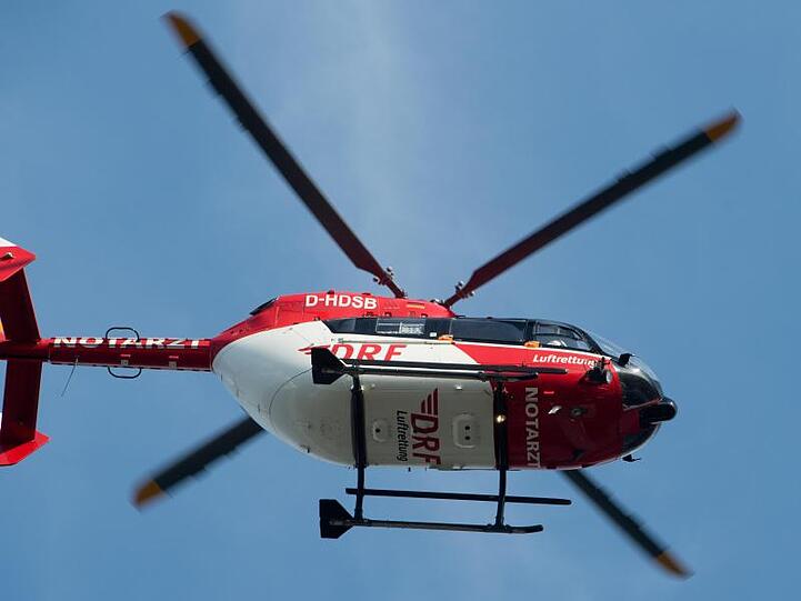 Ein Rettungshubschrauber fliegt über einen Flugplatz. Foto: Stefan Sauer/zb/dpa/Symbolbild