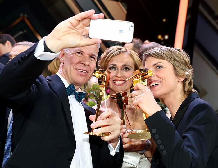Die TV-Journalisten Peter Kloeppel ("RTL Aktuell", l-r) Caren Miosga (ARD-"Tagesthemen") und Marietta Slomka (ZDF-"heute journal"), die in der Kategorie "Beste Information" ausgezeichnet wurden, machen ein Selfie.