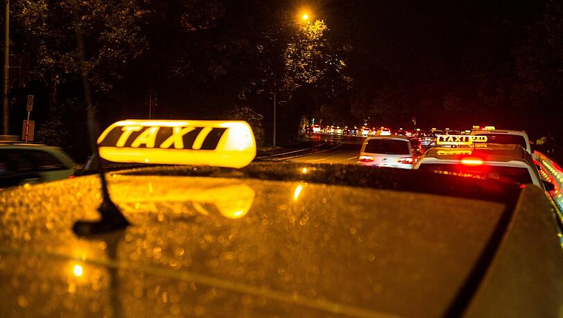 Ein Taxi wartet nachts in München in der Nähe der Theresienwiese auf Fahrgäste. Symbolbild