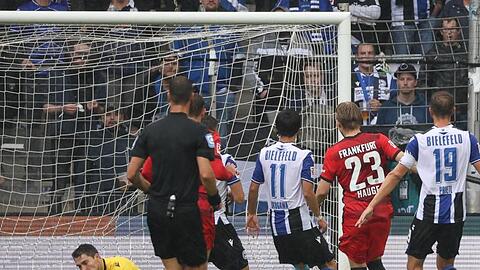 Bielefelds Torwart Stefan Ortega (l) kassiert den Gegentreffer zum 0:1 durch Frankfurts Jens Petter Hauge (2.v.r).