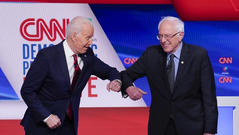 Bernie Sanders (r), und Joe Biden begrüßen sich mit ihren Ellenbogen.