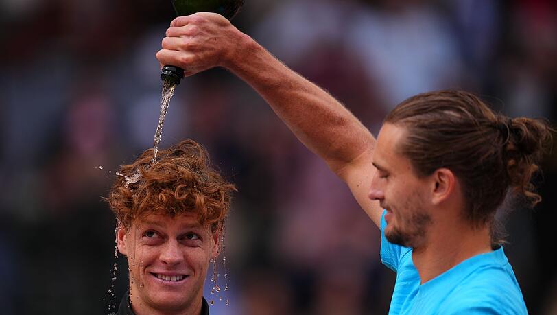 Zverev begie&szlig;t Sinner mit Champagner.