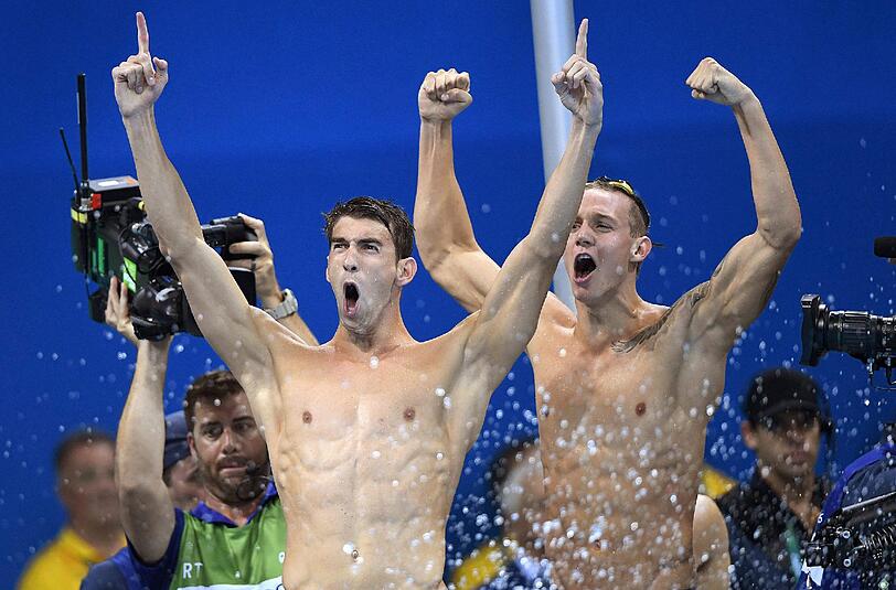 Michael Phelps (l.) und Caeleb Dressel feiern ihren Sieg der Freistil-Staffel über 4 x 100 Meter.