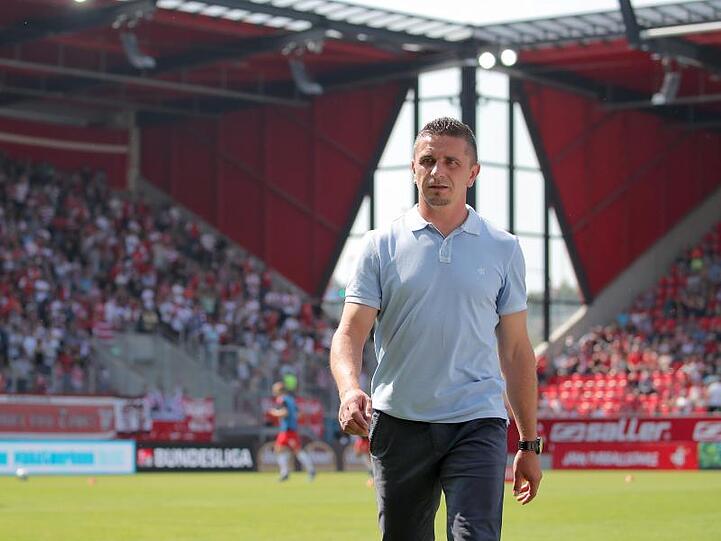 Der Regensburger Trainer Mersad Selimbegovic geht vor Spielbeginn über den Platz. Foto: Daniel Karmann/Archivbild