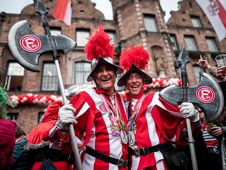 Fortuna-Fans und Karnevalisten feiern vor dem Düsseldorfer Rathaus.