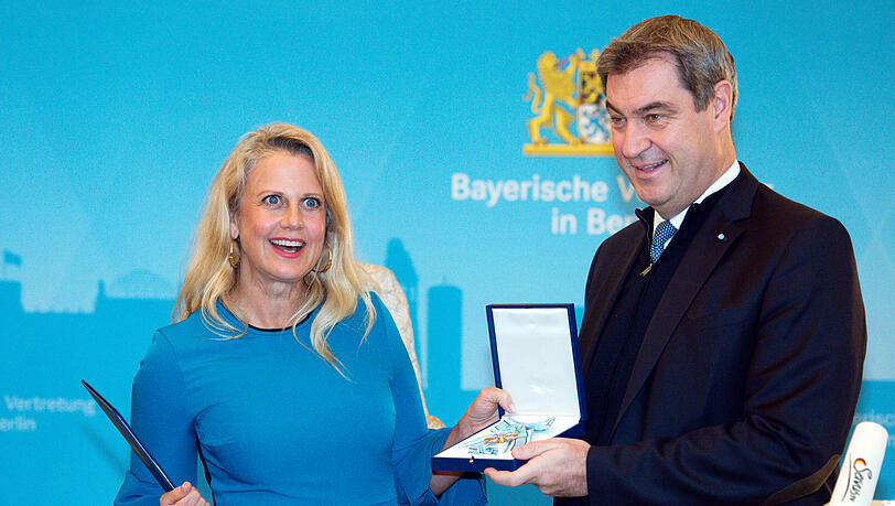 Barbara Schöneberger nimmt den Verdienstorden von Bayerns Ministerpräsident Markus Söder entgegen.
