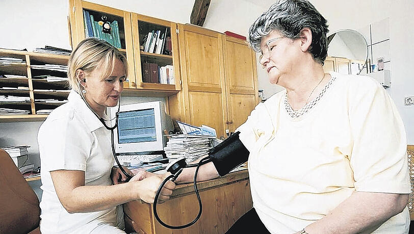 Patientin beim Blutdruckmessen in der Hausarzt-Praxis.
