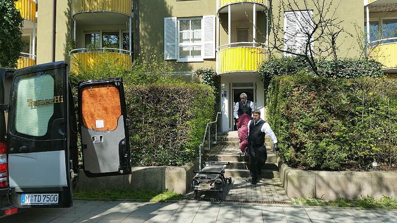 Mitarbeiter des Bestattungsinstituts Denk tragen die Tote aus dem Mietshaus im Dantepark im Stadtteil Gern.