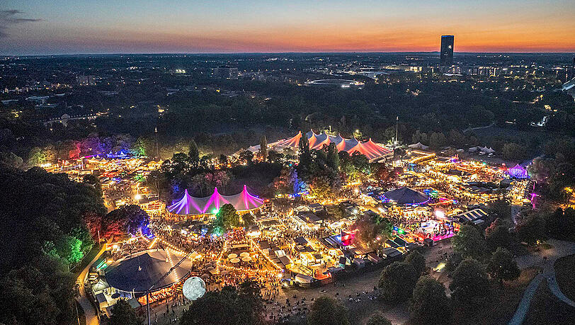 Sommer in der Stadt: Wenn die Zeltstadt am Fu&szlig;e des Olympiabergs leuchtet, ist Tollwood-Zeit.
