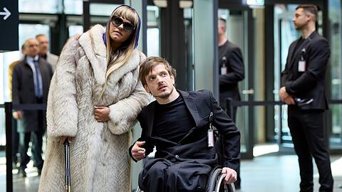 "Gar kein Geld macht auch nicht glücklich": Olivia (Sara Fazilat) und Sammy (Jan Kampmann) haben die Personenkontrolle bei der Veranstaltung anlässlich der Zulassung des HIV-Impfstoffes überwunden.